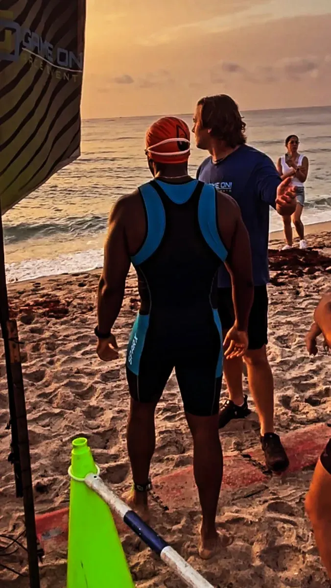 Rob in swim gear on the beach at a triathlon start.